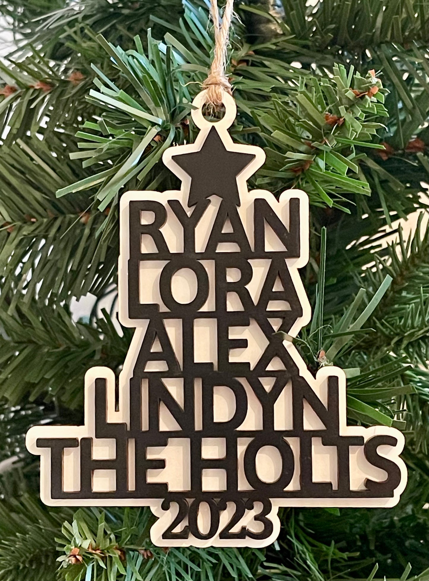 Art by Iceberg offers a fully customized Christmas tree ornament with your own family and pet names or whatever words you want to add.