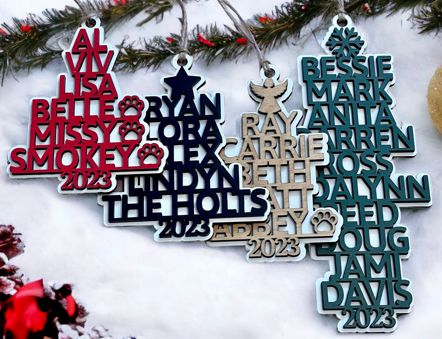 Image shows four examples of the personalized family name tree Christmas ornament from Art by Iceberg.