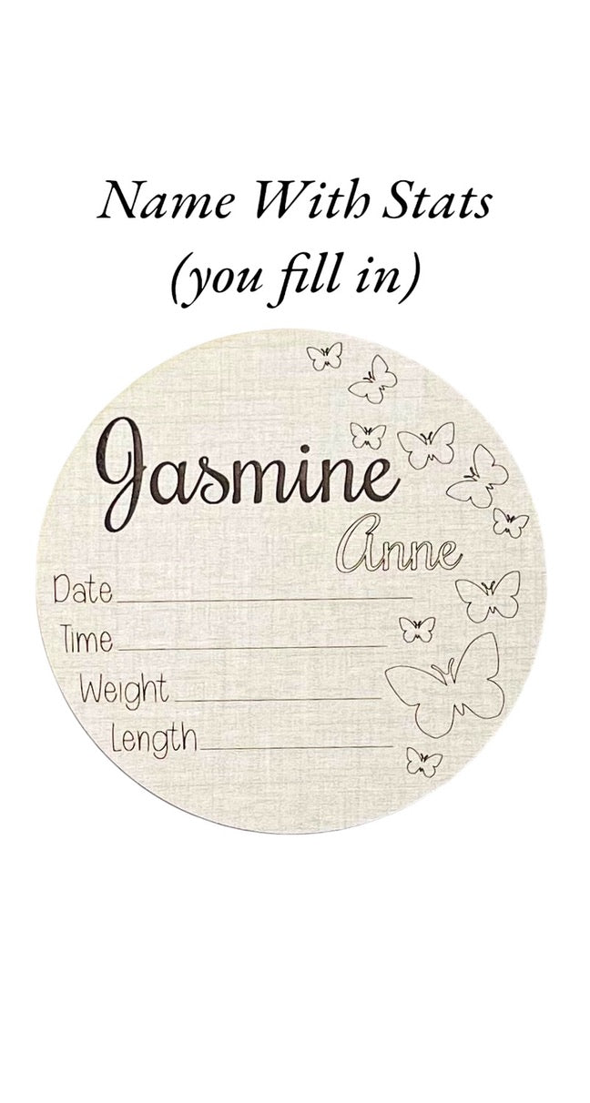 Engraved name baby birth announcement signs. Five inches round. Butterflies along the right side. Shown in the linen and maple wood options. Ideal baby shower gift and nursery or hospital photo prop.