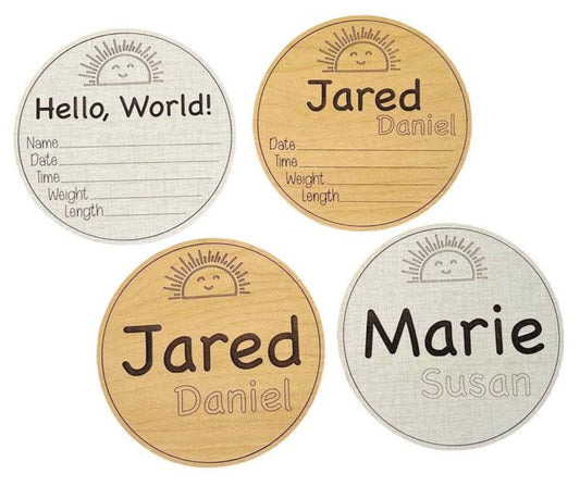 Baby birth announcement sign. Five inches round with engraved name and an area for birth stats. Cute sunshine smiling sun engraved at the top. You fill in birth stats with a pen or marker. Choose linen or maple wood color. From Art by Iceberg.