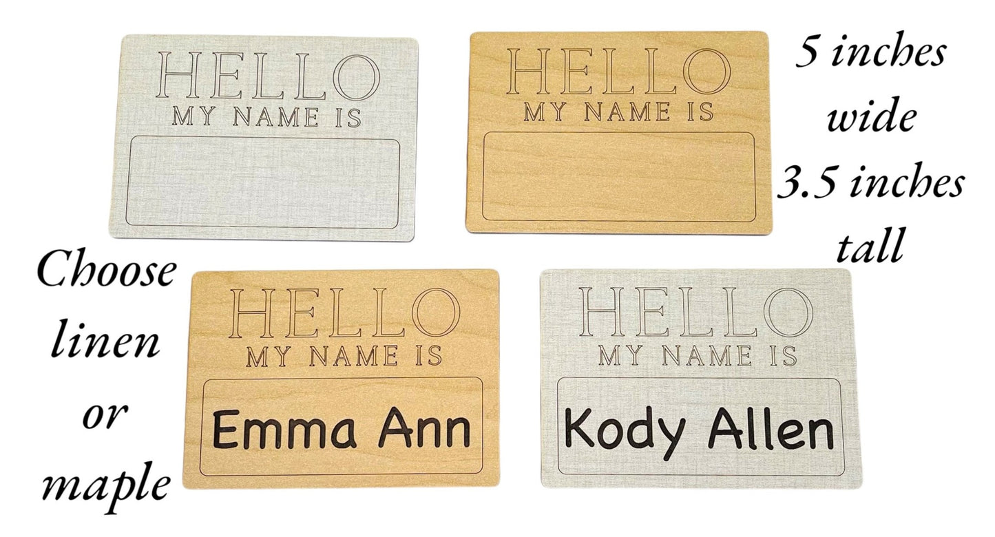 Personalized new baby name gift idea. Baby birth announcement with the Hello My Name Is name tag theme. Engraved name, or you can fill in the name on your own. Ideal bridal shower gift. Choose from linen or maple wood.