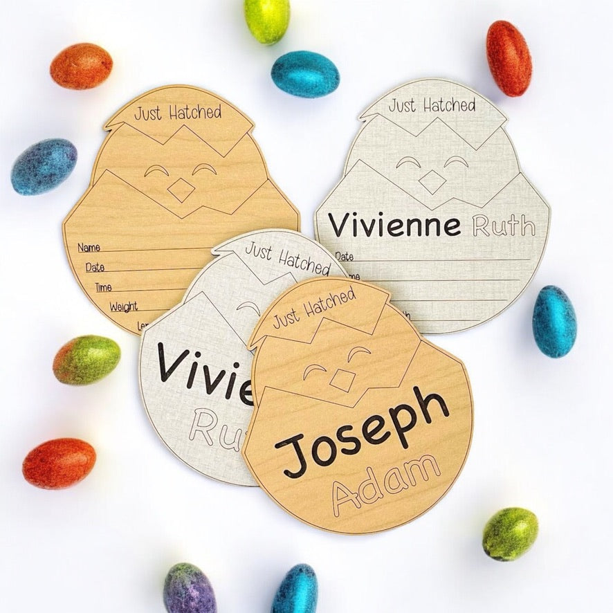 Baby photo prop for hospital or nursery. Shaped like a baby chick emerging from an egg, with Just Hatched engraved at the top of the egg. Engraved name and birth stat area. Baby birth announcement sign with a cute, original design from Art by Iceberg.