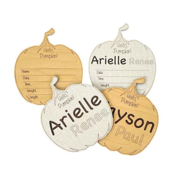 Hello, pumpkin! Shaped baby birth announcement sign ideal for fall babies! Engraved first and middle name, area for birth stats below. Choose maple or linen color. Cute photo prop or baby shower gift. From Art by Iceberg.